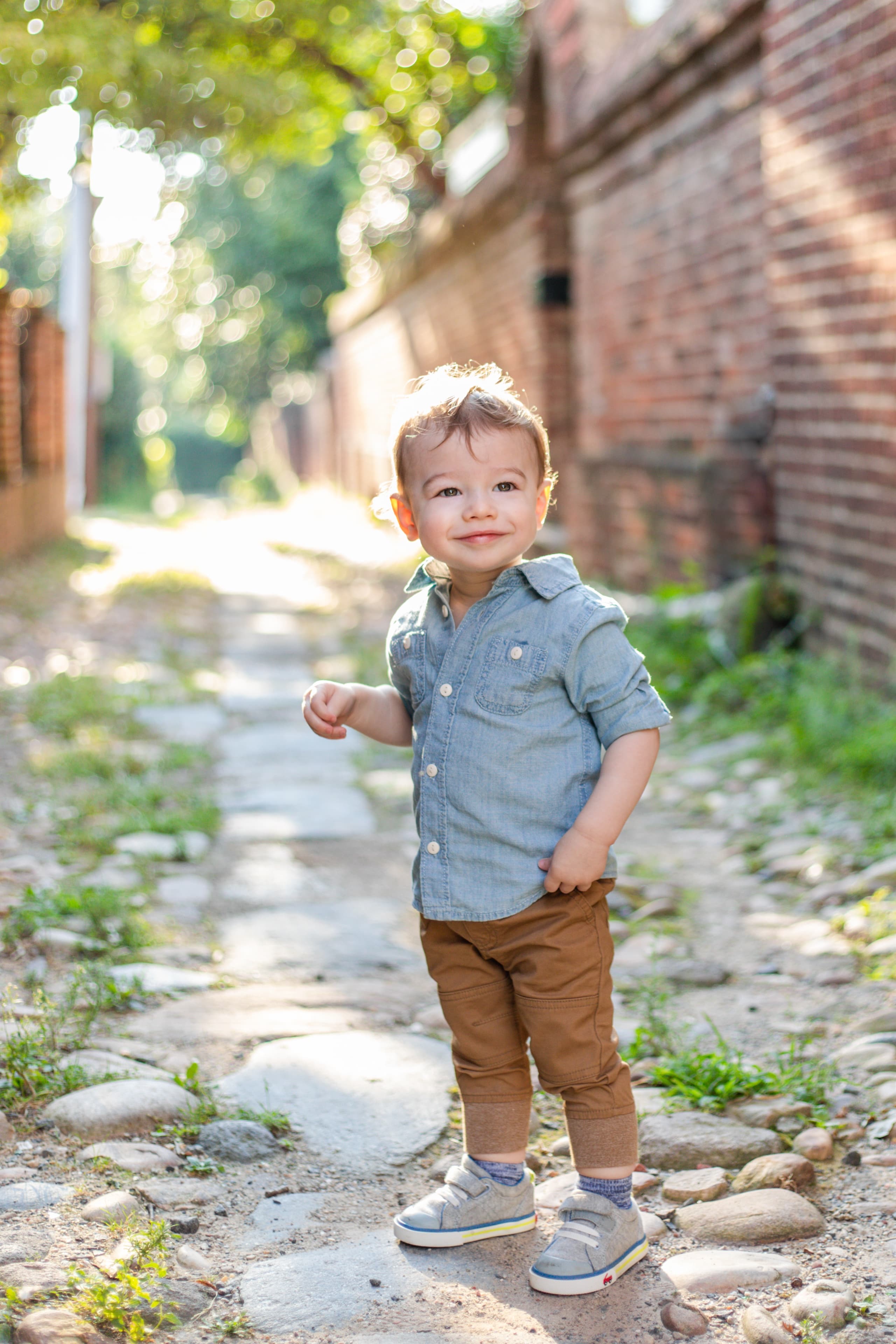 Toddler in chambray on a cobblestone alley